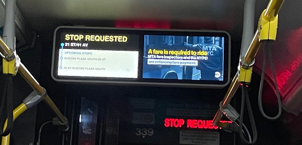 Photo of a bus display listing stops on the left and a PSA on the right stating ‘ a fare is required to ride’