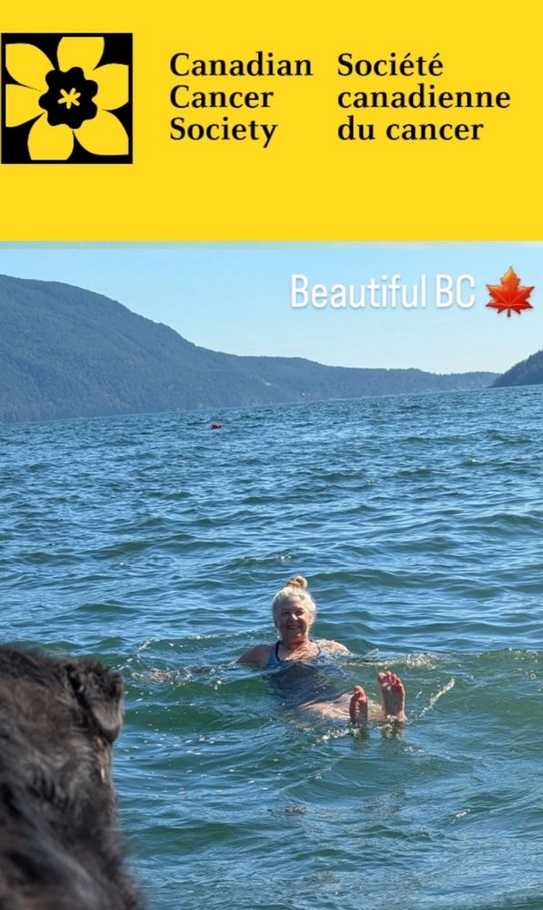 White woman happily floating in blue ocean with landscape behind her. An image advertising a Cancer research fundraiser for August 2025