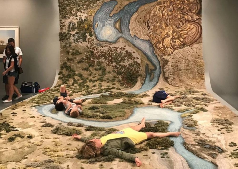People lying on beautiful hand woven Art installation by Alexandra Kehayoglou.