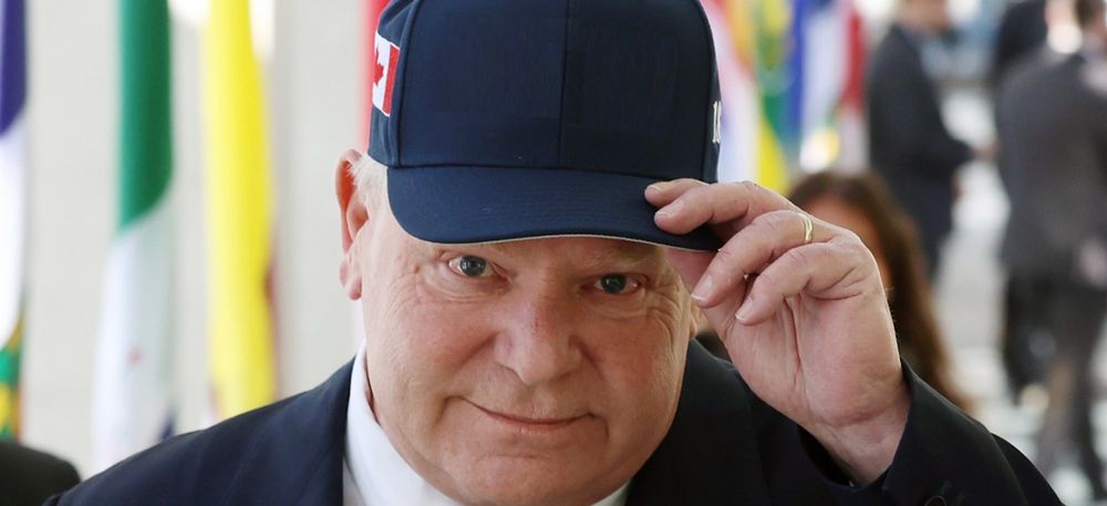 Doug Ford attempts to look serious while a mariachi band composed entirely of monkeys plays on a loop inside his head. It's a big band. They have room.

The hat is blank. Please add a message of your own.