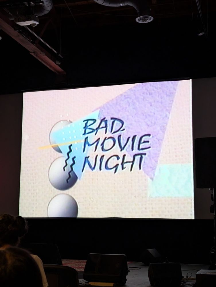 "Bad Movie Night" with an 80s themed background 