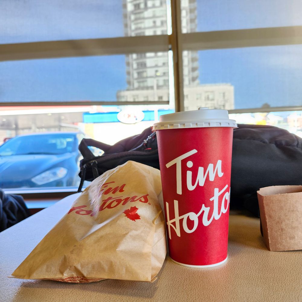 Special olympics donuts in a bag and coffee.