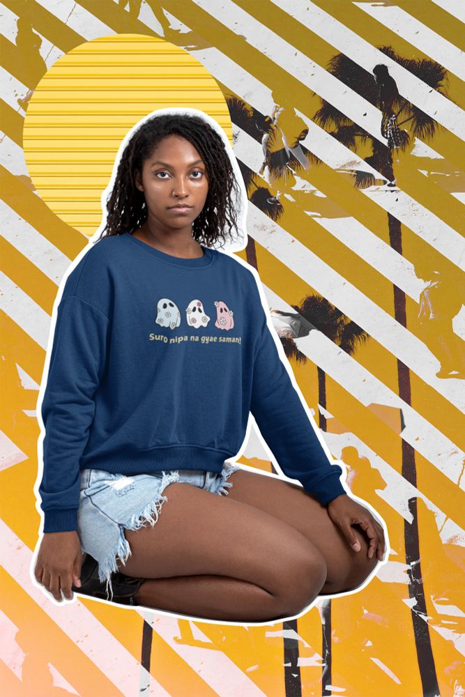 Model wearing a dark blue Suro Nipa sweater, kneeling in front of an edited beach backdrop.