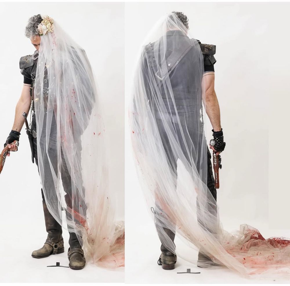 Front and back photos of Taika Waititi as Blackbeard trying on a bloodied veil without his wig.