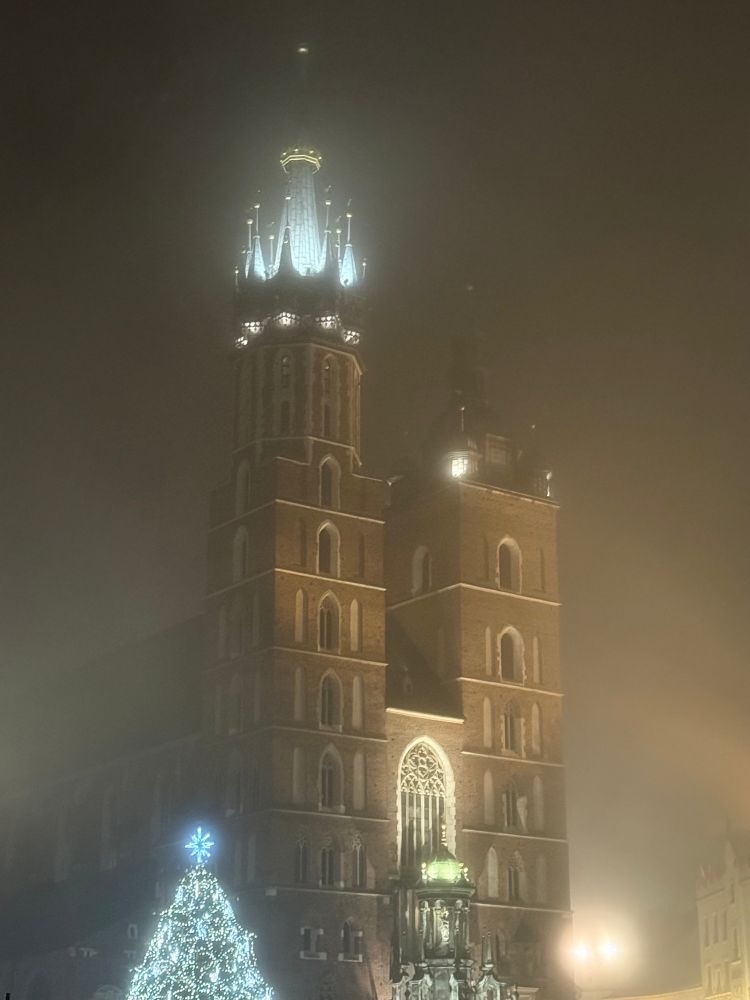 Krakow market place in the fog with Christmas lights