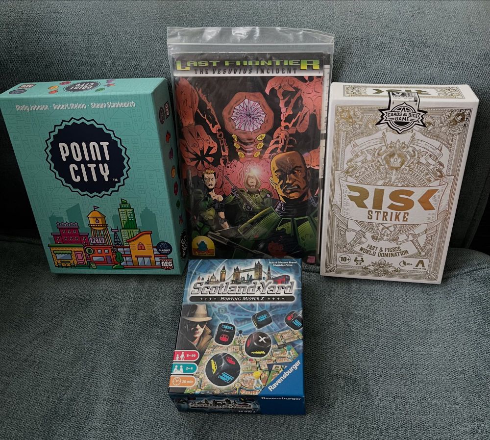 Box art for Point City, Risk Strike, Last Frontier the Vesuvius Incident, and Scotland Yard Hunting Mr X boardgames.