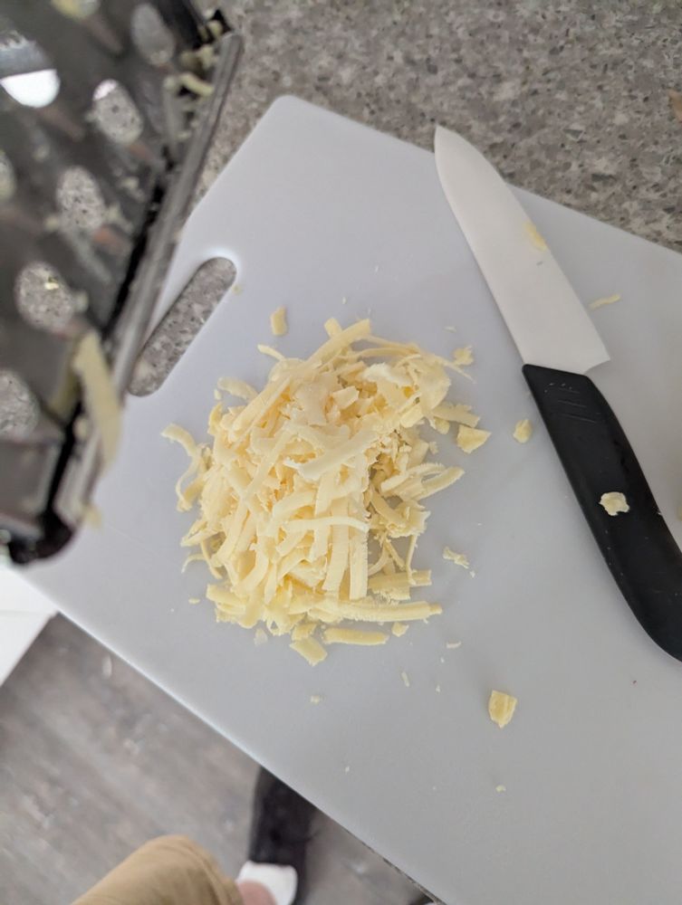 Shredded aged white cheddar cheese. 