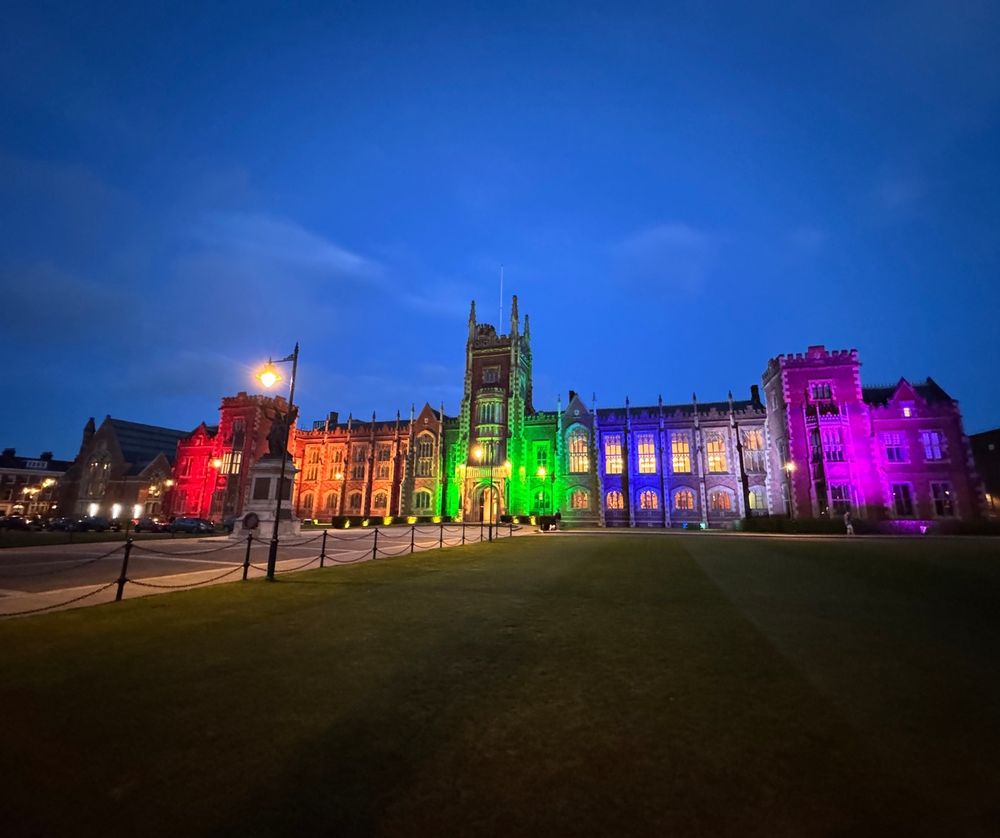 Image shows the Lanyon Building lit up in rainbow colours