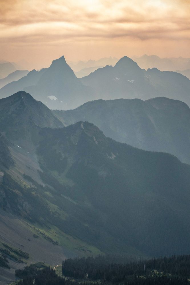 Sunset in the Pasayten Wilderness, with the distinct double-summited Hozomewn Mountain rising behind ridges captured from Full Moon Rising near the Canadian border.