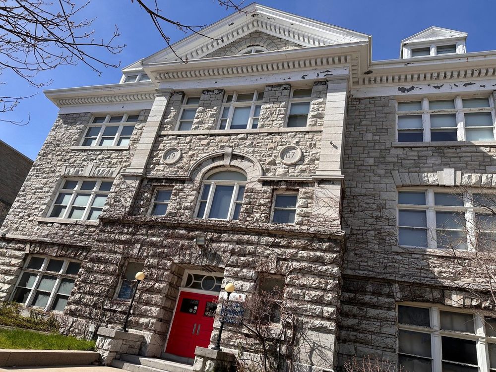 Front view of Kathleen Ryan Hall with blue skies in the background