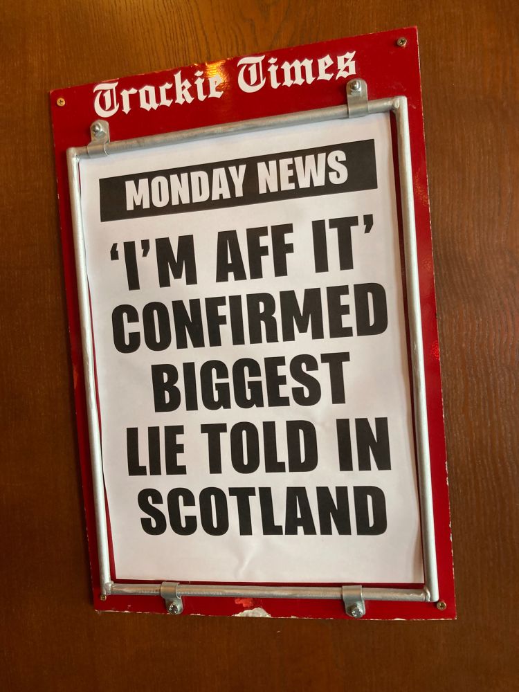 Headline on newspaper billboard 