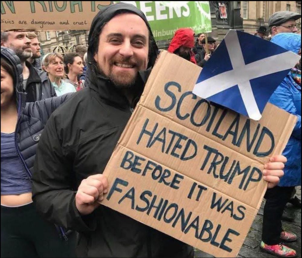 A person holding a sign saying 