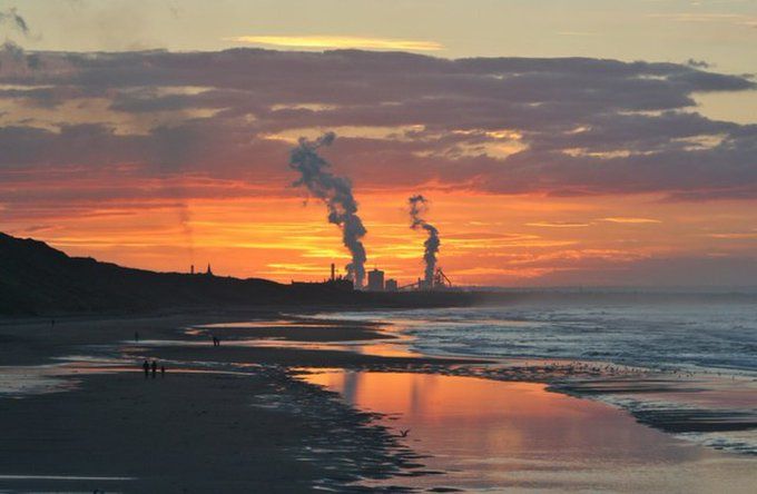 Late summer evening image (2006) from Saltburn pier  with Redcar Steel works in the background.