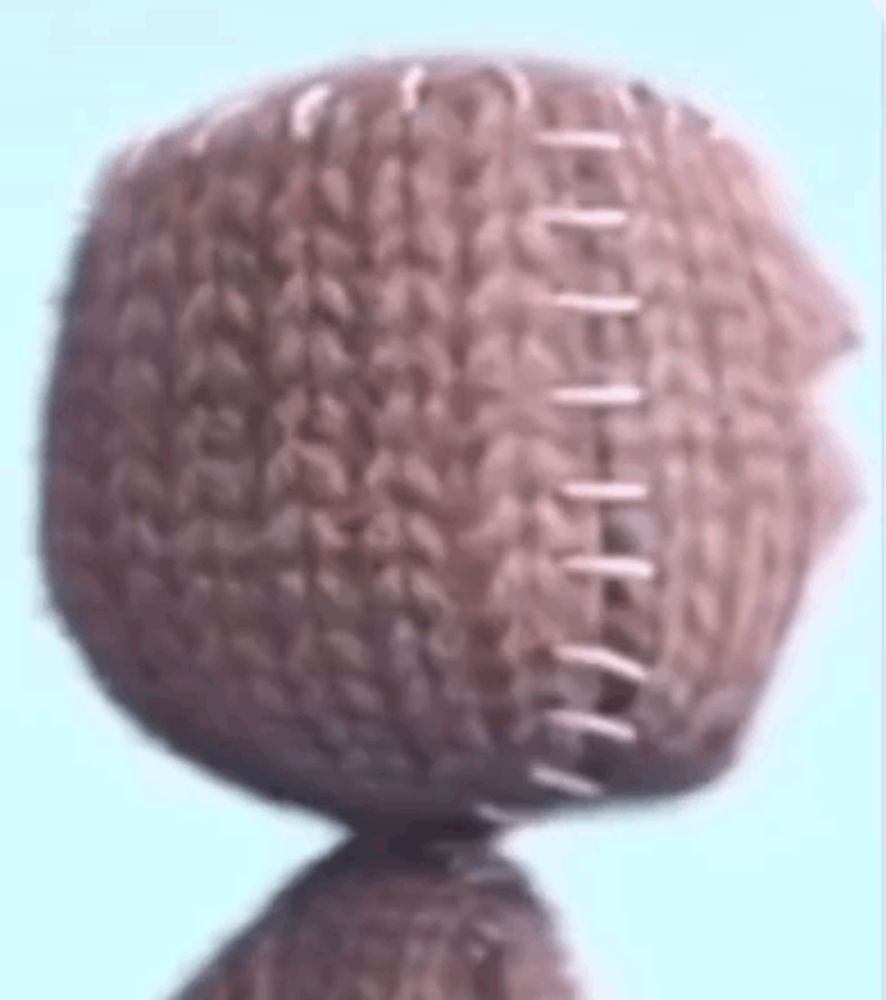 a close up of a knitted ball with stitching on it .