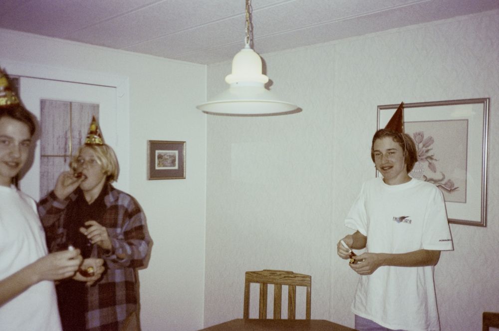 my birthday party, my friends brent and kris to the left, and me on the right in a party hat and final fantasy 7 t-shirt