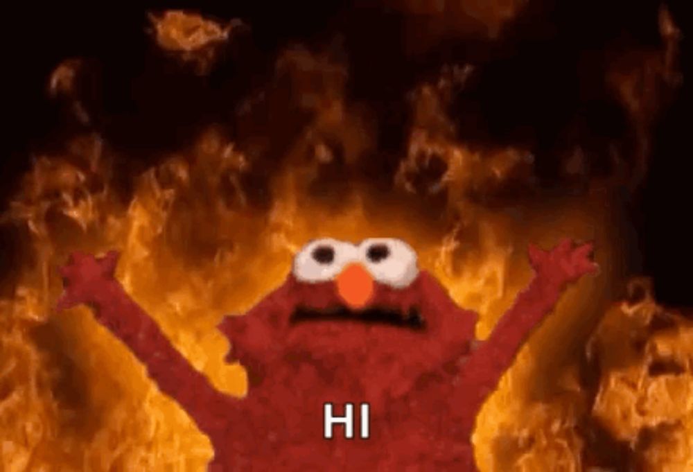 elmo from sesame street is standing in front of a fire and says `` hi '' .