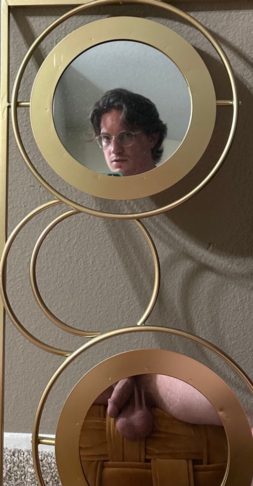 A picture of a circular mirror decoration. The top mirror shows my face and the bottom mirror shows my softie and balls. They’re soooo heavy 😩😩