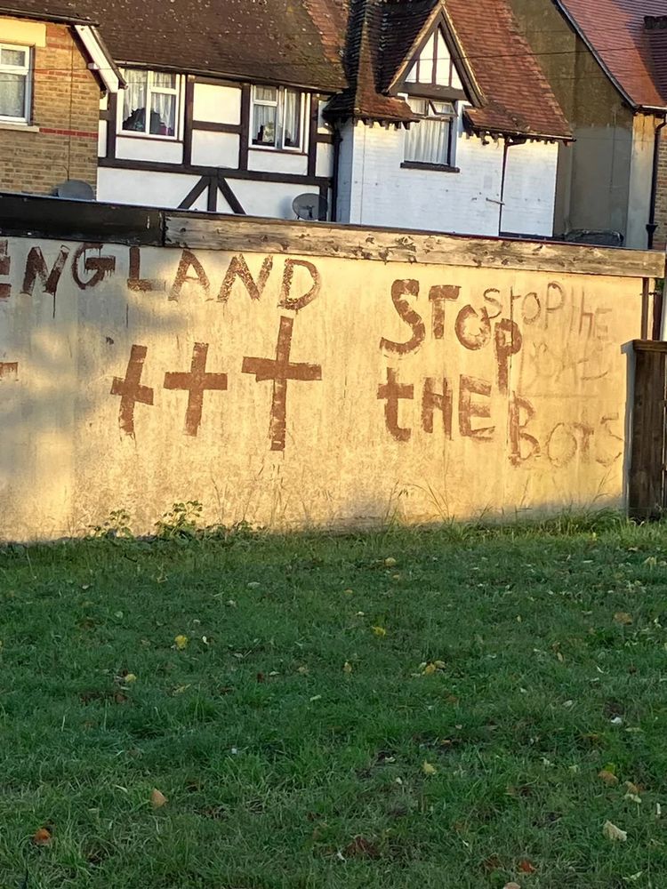 Photograph of a wall with graffiti that reads 