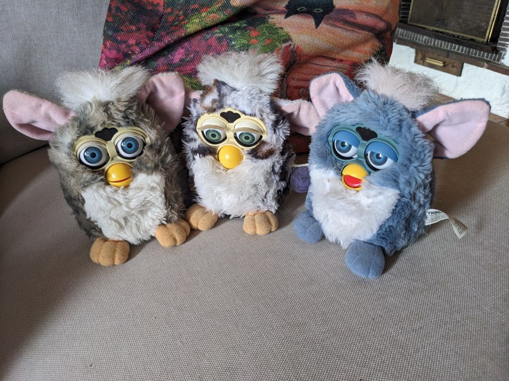 A trio of furbies: an owl, a snow leopard and an elephant.