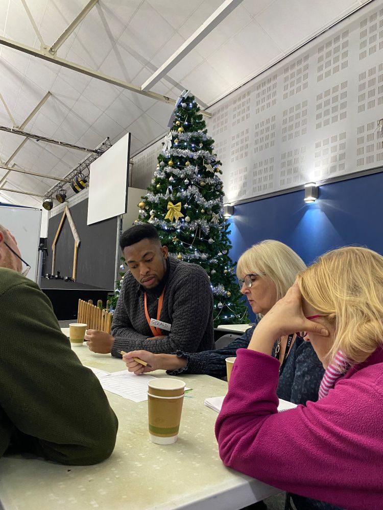Workshop participants chat around a table