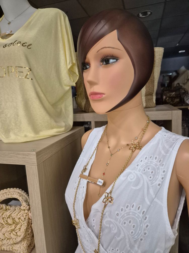 Shop store dummy, as in the Kraftwerk song, but this is on france. Her hair is curved round over her ears and down the side of her head to a point near her chin.