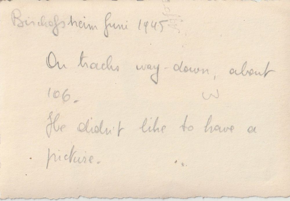 Pencil annotations on the back of the photograph read ‘Bischofsheim Juni 1945‘ ‘On tracks way-down, about 106. He didn't like to have a picture’. On the side a faint 'Agfa’ watermark can be seen.