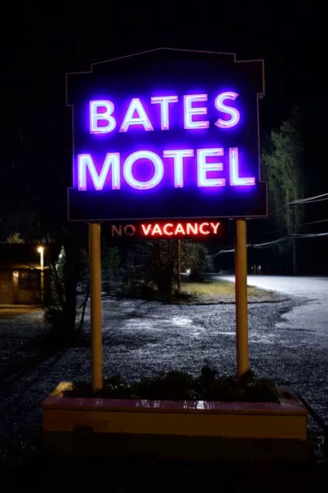 a neon sign for the bates motel says no vacancy