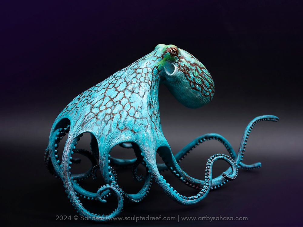 A large Caribbean Reef Octopus sculpture, posed as if moving quickly and gracefully on its limber arms