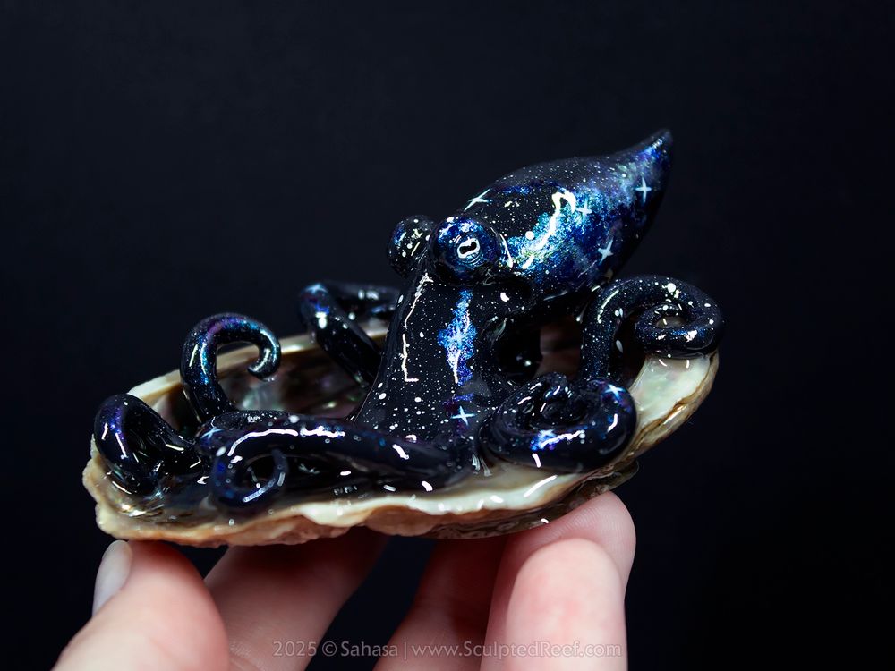 Alya the Nebula Octopus, hand sculpted from clay and lovingly painted in a royal blue on black Nebula theme.