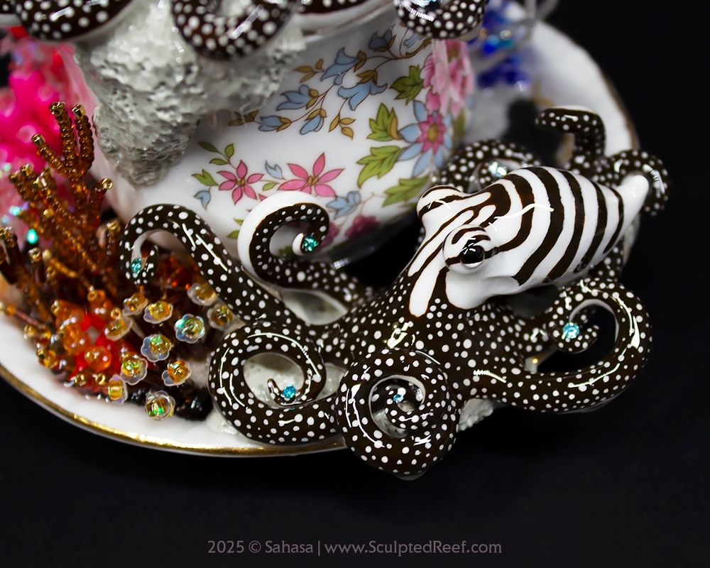 Larger Pacific Striped Octopus sculpture handmade from clay and lovingly painted. 

The octopus sits on a vintage tea set and is surrounded by handmade corals in warm colors.