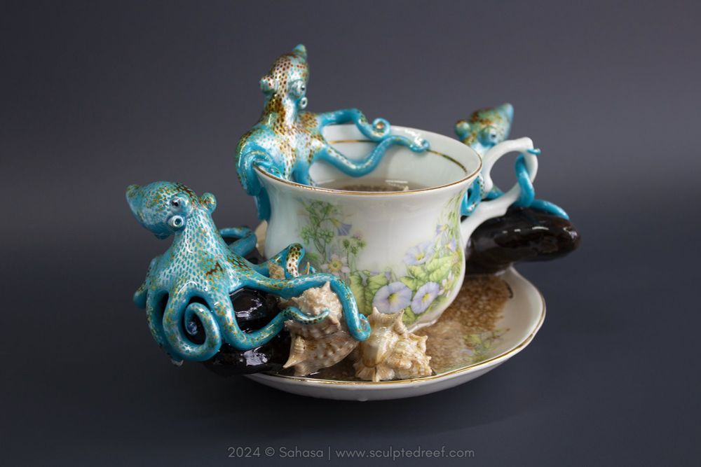 A hand made artwork featuring three hand sculpted and painted Caribbean Reef Octopuses