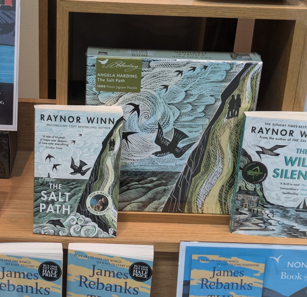 A Waterstones window display featuring the works of Raynor Winn, and a "Salt Path" jigsaw 