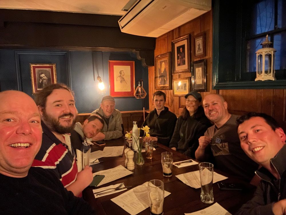 A picture of the cert-manager maintainers sat around a table, smiling into the camera