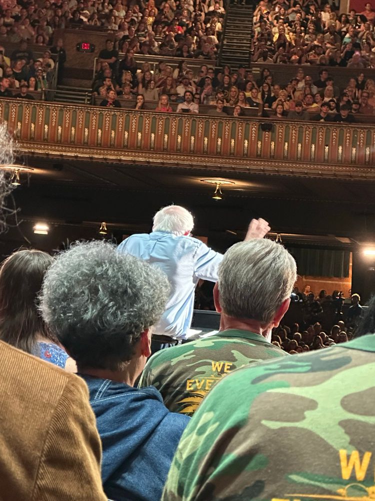 A view from behind of Bernie Sanders speaking on stage at the Capitol Theatre in Wheeling, WV on August 8, 2025. It was standing-room only. The energy and enthusiasm was palpable. West Virginians are fired-up! 