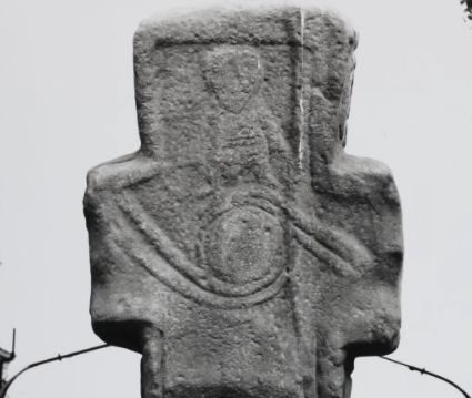 an early medieval carved cross from Netherton possibly from the Govan School it shows a figure standing on top of a globe with two serpents wrapped round it 