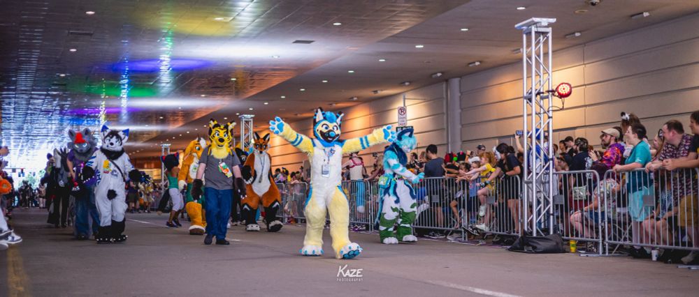 Fursuiters walking down 10th St underneath the David L. Lawrence Convention Center in the Anthrocon 2024 Fursuit Parade.