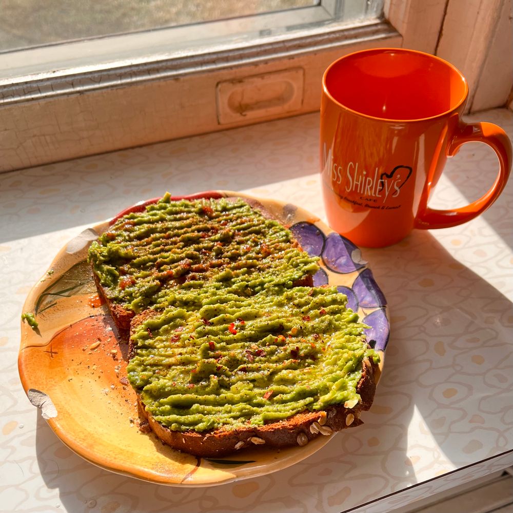 Avocado toast with olive oil and red pepper flakes on one slice, old bay and snake oil hot sauce on the other (the baltimore special). Nutritional yeast, salt, pepper, garlic and onion powder of course