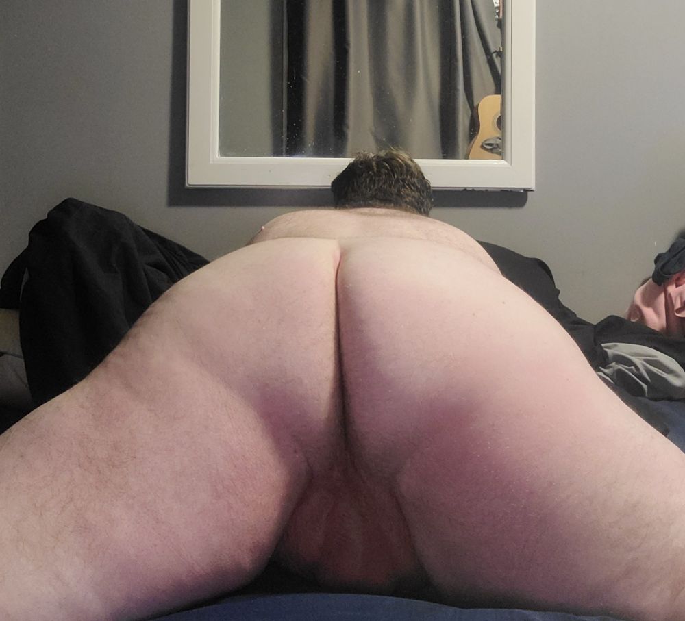 Chubby boy laying naked on his stomach, showing his butt