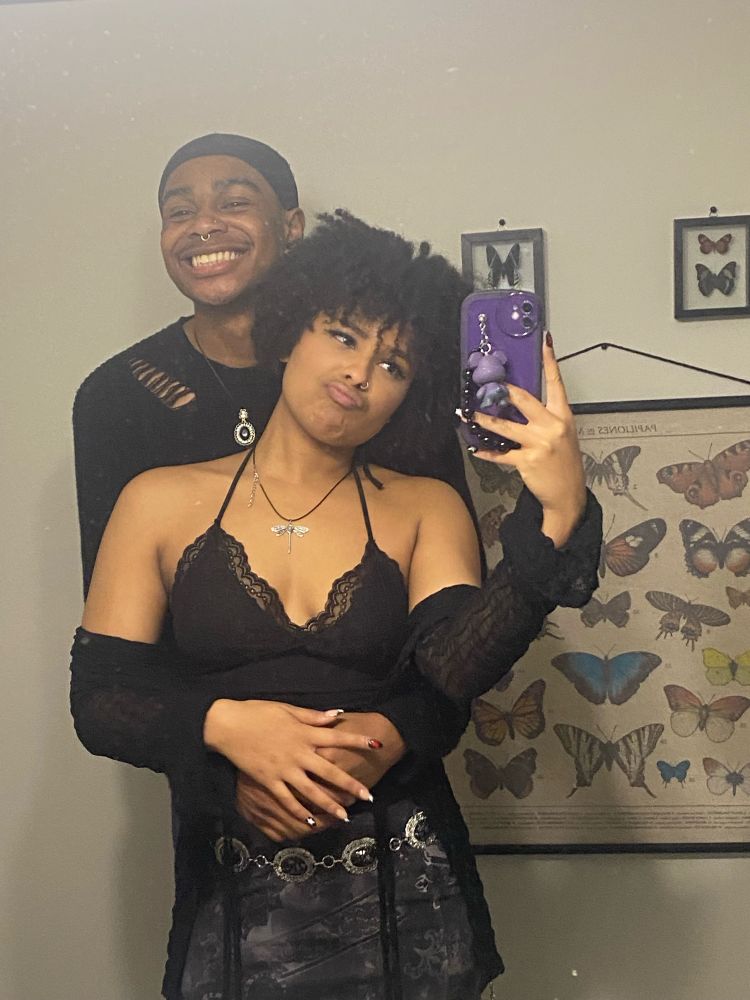 my bf hugging me from the back and smiling, both of us are wearing all black