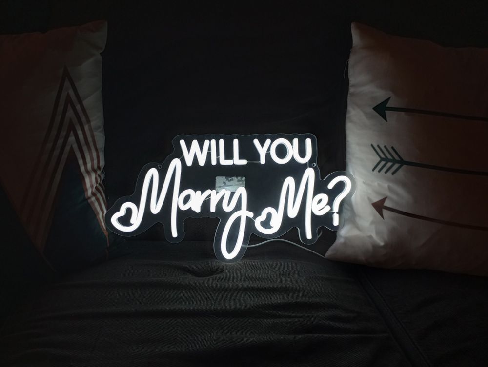 Neon sign with the words "Will you marry me?" Illuminated 