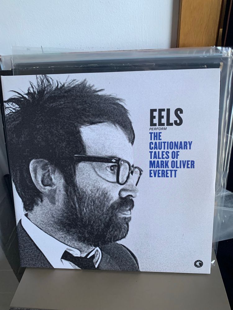 eels album cover, photograph of a bearded man wearing a tie and glasses 