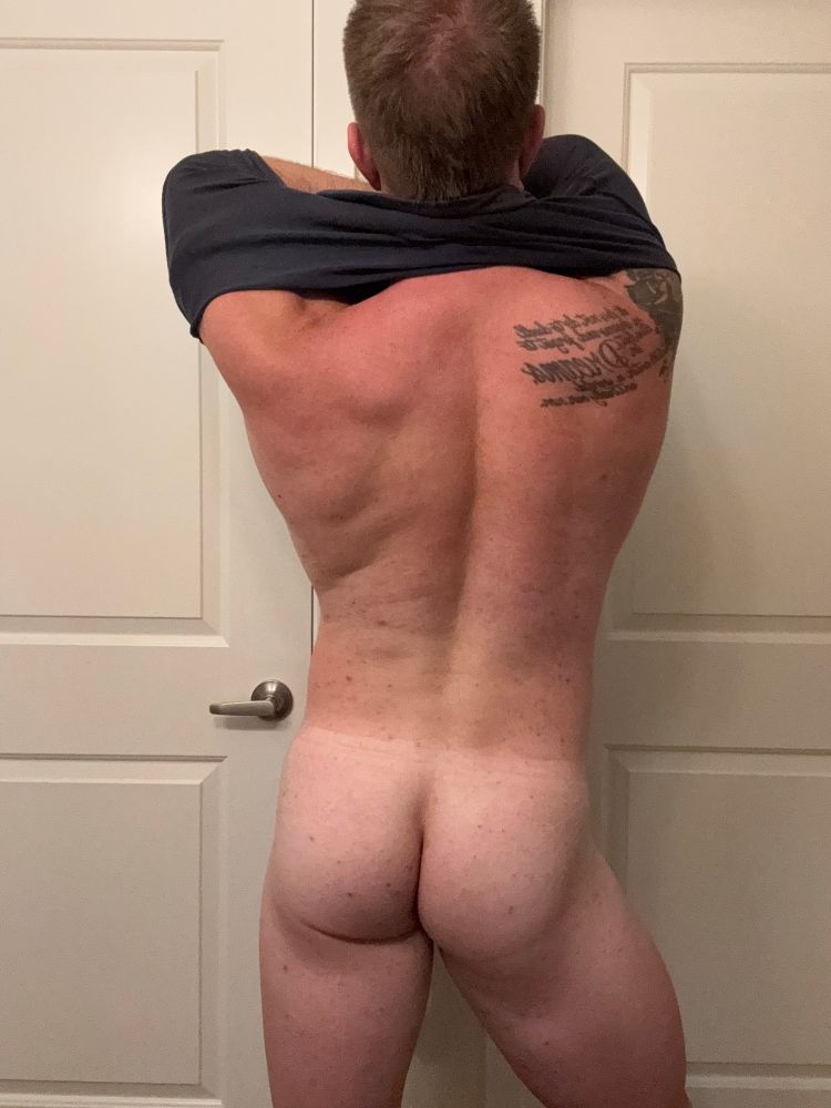 Nearly naked and taking off my shirt. Behind shot. 