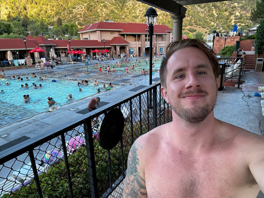 Smiling selfie in front of a big pool