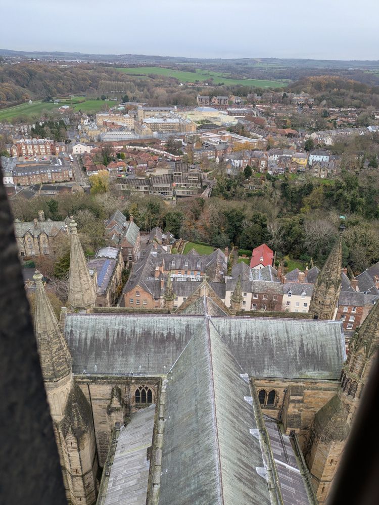 view onto roof of durham cathedral with fields in distance