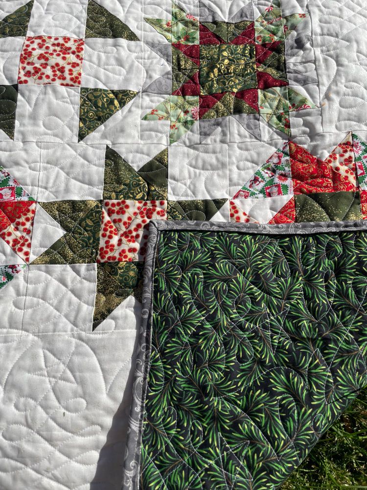 A close up showing the pine tree themed backing and binding