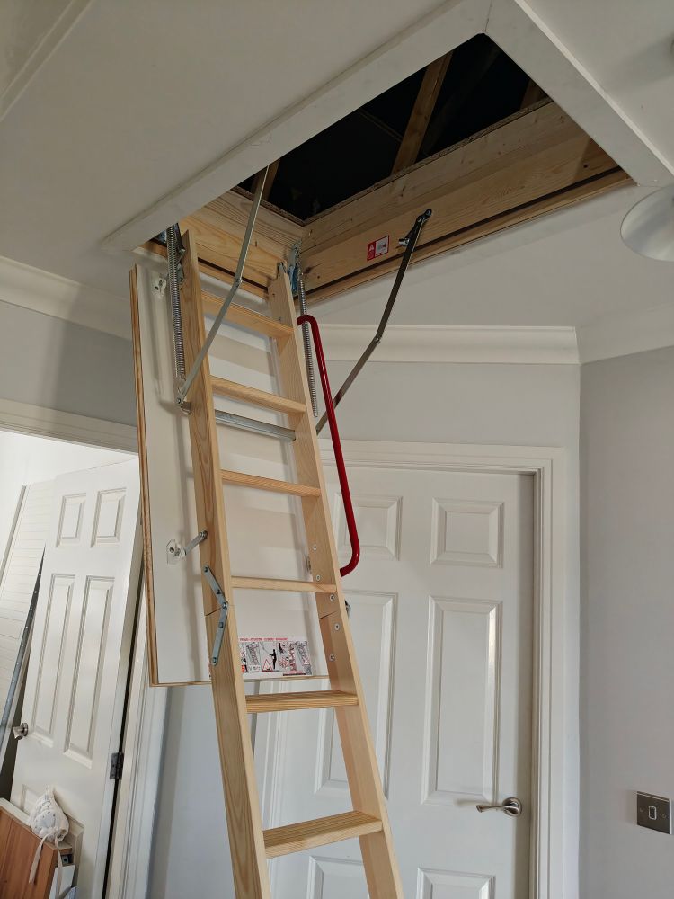 Wooden luxury loft ladder fully unfolded and presenting a wide loft hatch