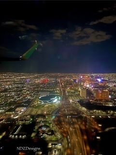 Photo taken of the Las Vegas valley city lights sitting behind the wing, visible are the resorts, stadium and traffic 2024