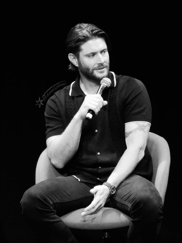 A black and white photo of Jensen Ackles taken at Comic Con Wales in 2024