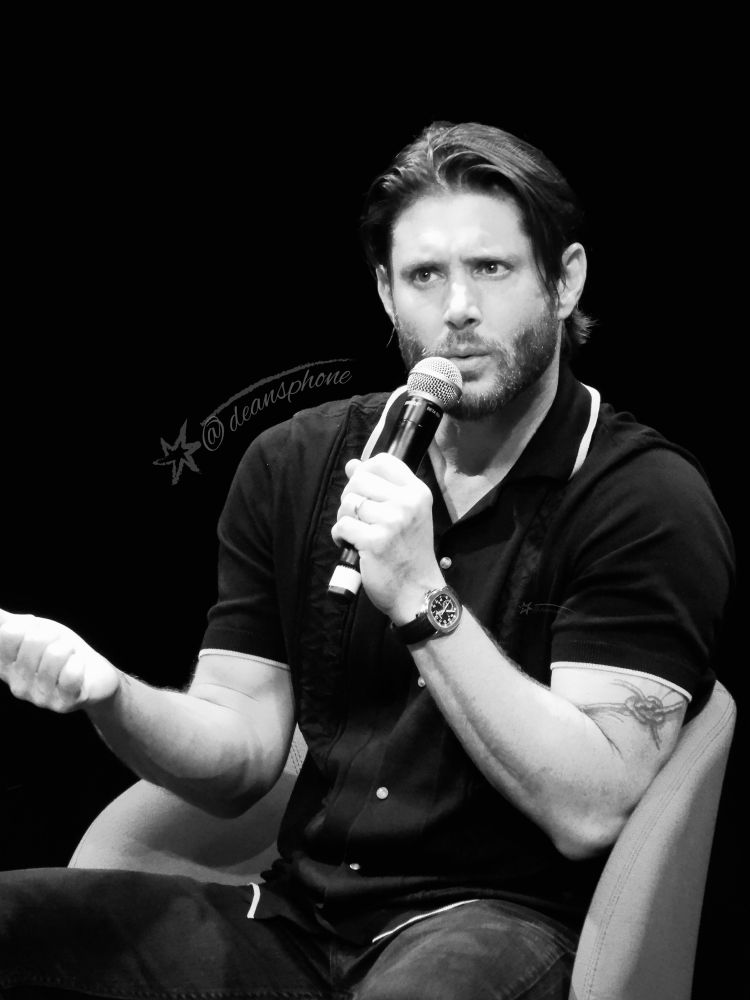 A black and white photo of Jensen Ackles taken at Comic Con Wales in 2024