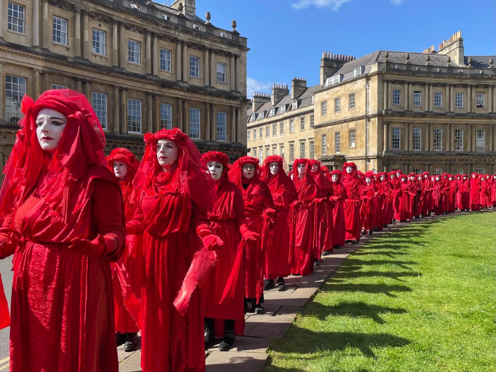 Red Rebels attend a Funeral For Nature in Bath - processing around the Circus.